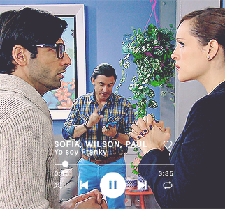 Sofía and Paul looking at each other. Wilson in the background looks angry.